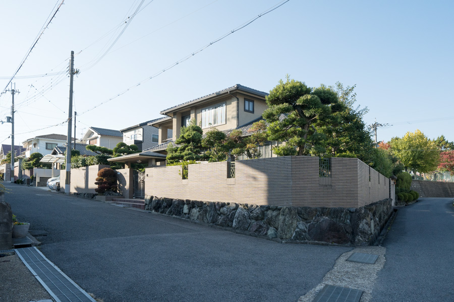 建物全景。既存の植栽をコンパクトにし塀にガラスブロックを配置しています